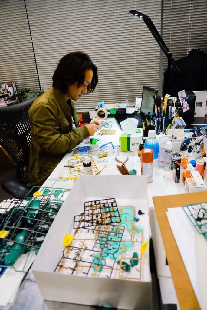 Yoji Shinkawa assembles a Metal Gear RAY statue in Kojima